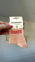 Chaussette à paillettes rose avec inscription "Coquette"